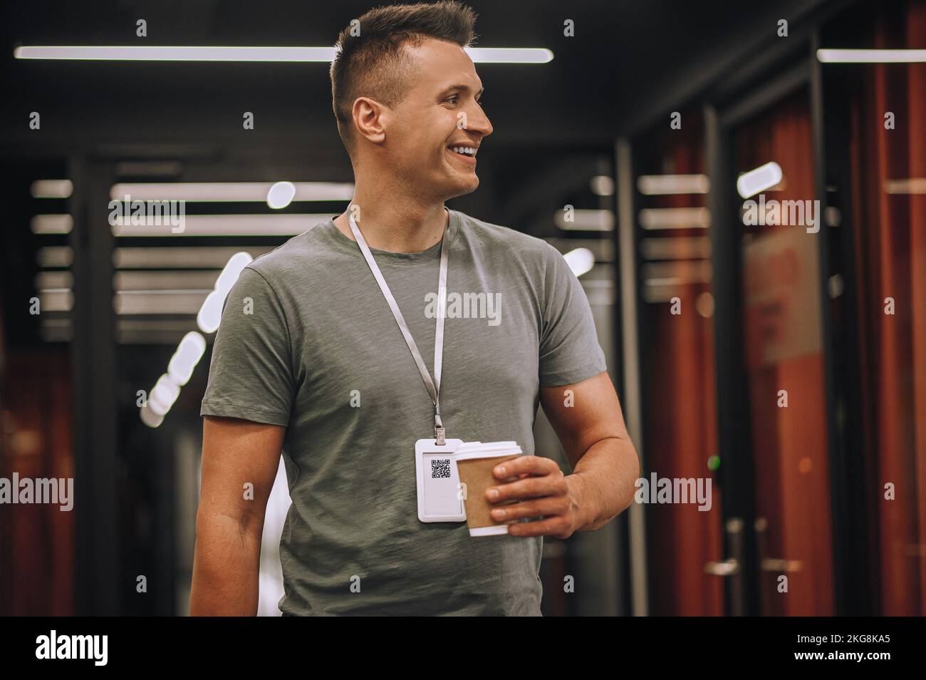 Smiling employee holding a beverage in a disposable paper cup Stock ...