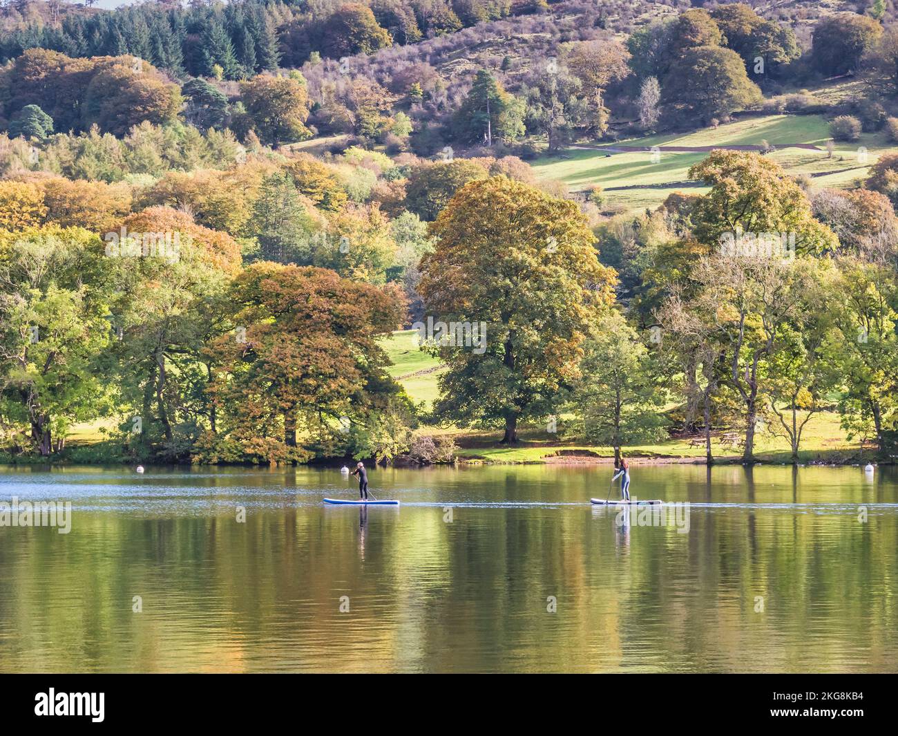 The image is of two young women paddle boarding at Lakeside on lake