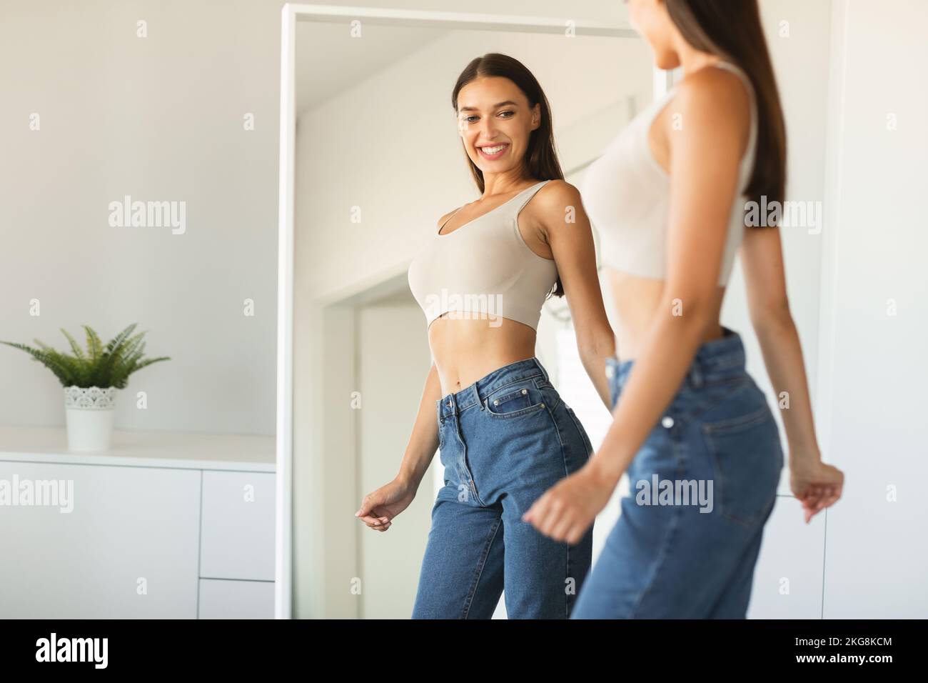 Woman jeans mirror happy hi-res stock photography and images - Alamy