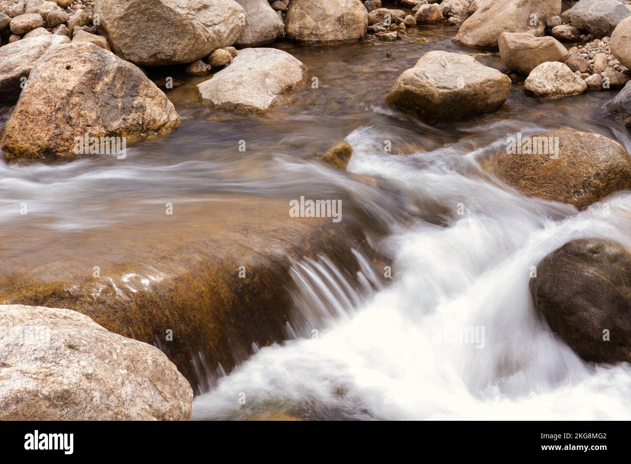 A closeup of water rushing over the rocky creek landscape Stock Photo ...