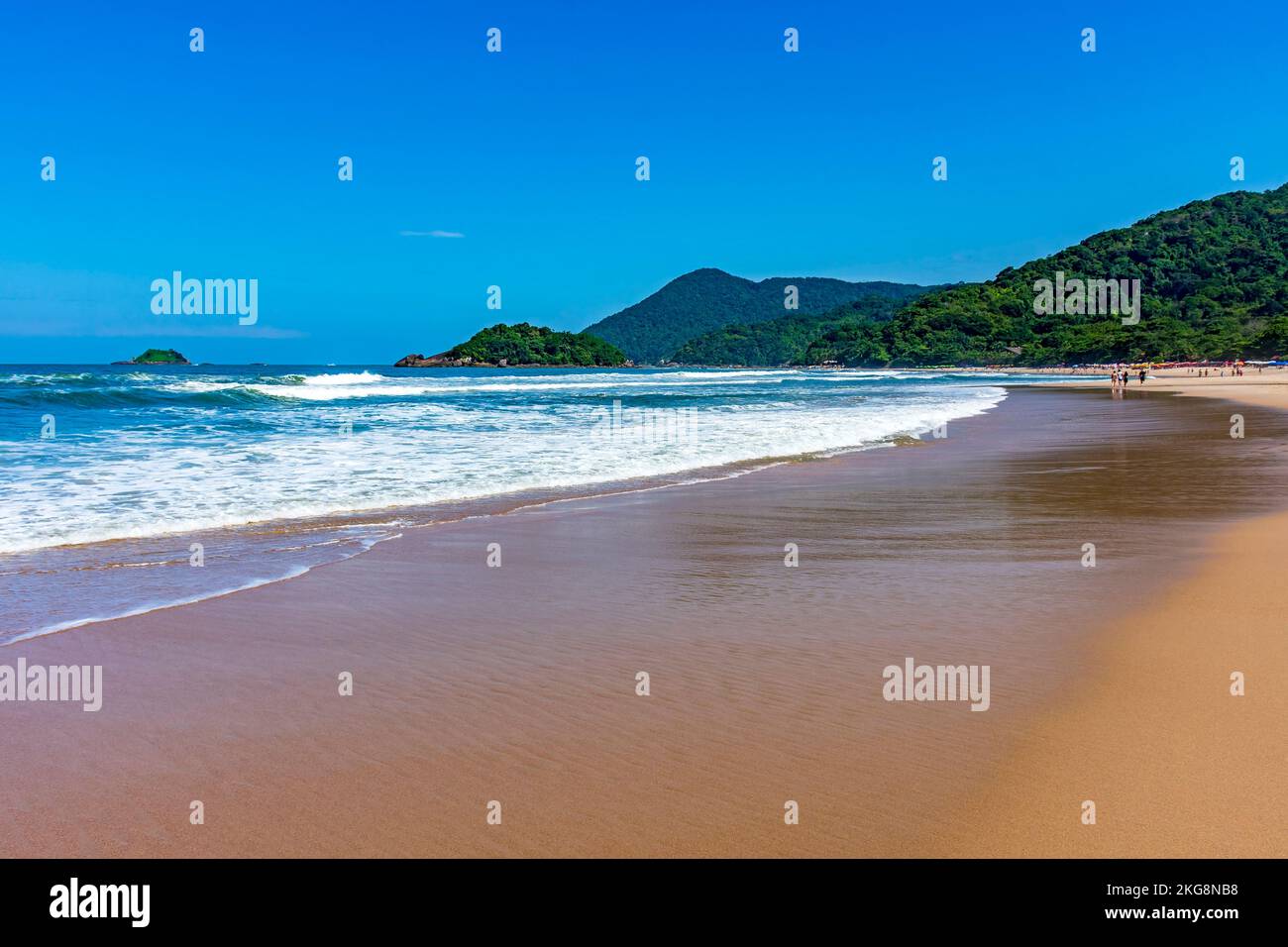 Paradise beach surrounded by rainforest and hills on a sunny day in Bertioga on the coast of Sao Paulo Stock Photo
