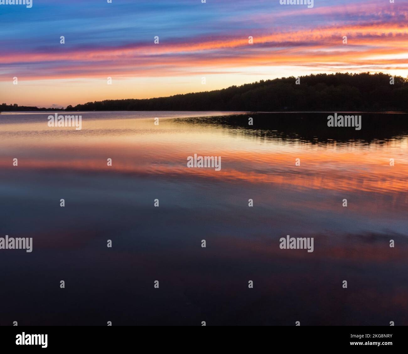 A sunrise at Staunton Harold reservoir on the Derbyshire Leicester border in the uk taken as blue hour moved into golden hour. Stock Photo