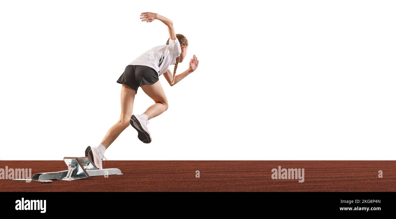 Young athlete, beginner female track runner bursting off starting block