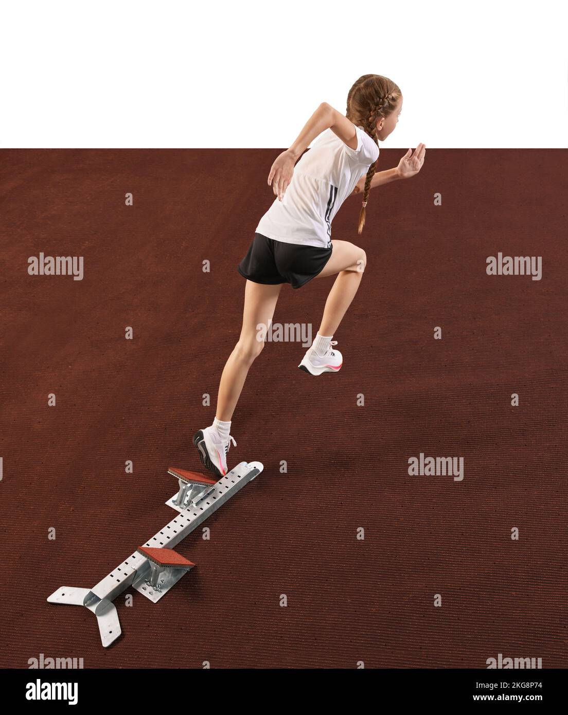 Young athlete, beginner female track runner bursting off starting block