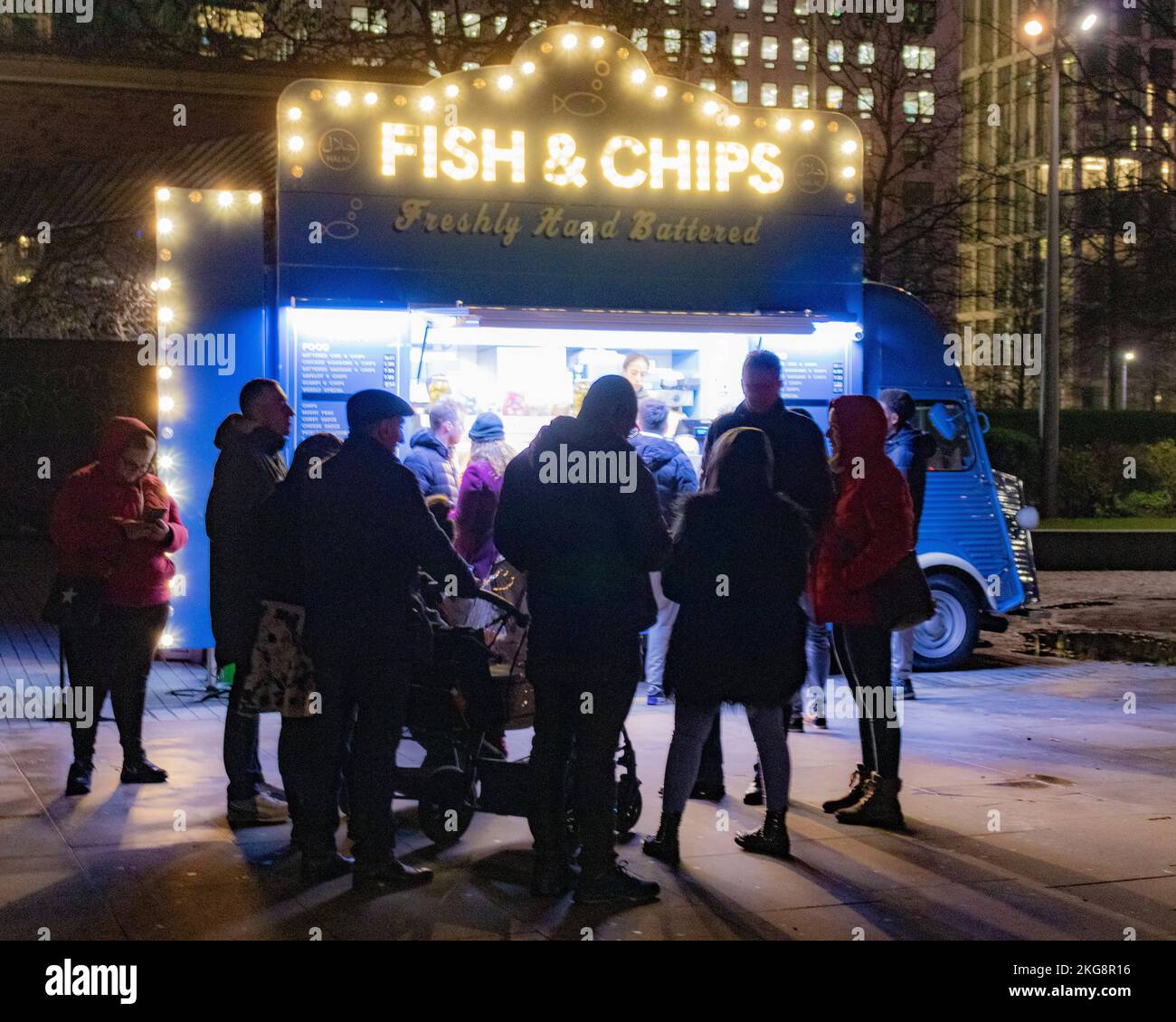 A crowd of people queuing at a Fish and Chips van on the south bank, ay