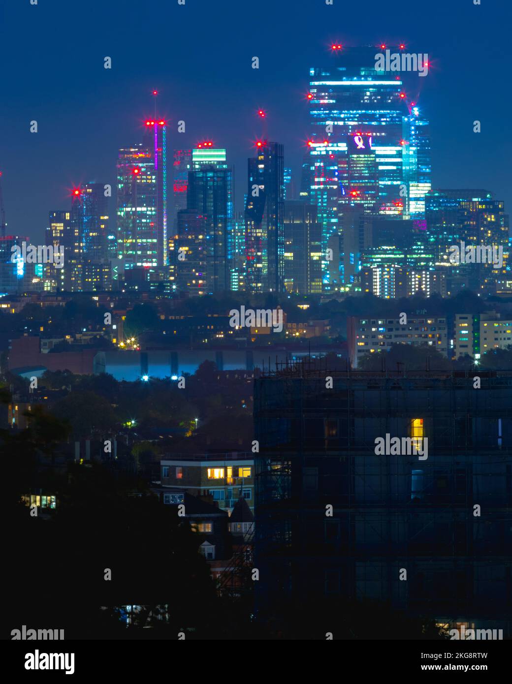 A view of the London skyline taken at night with light trails, showing a range of important and famous buidings against the back drop of a blue night Stock Photo