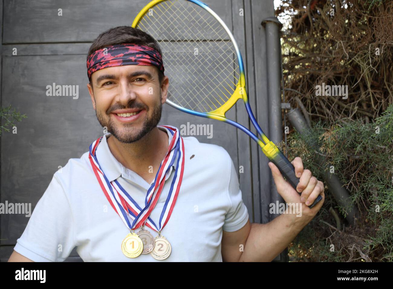 Successful male tennis player with medals Stock Photo Alamy