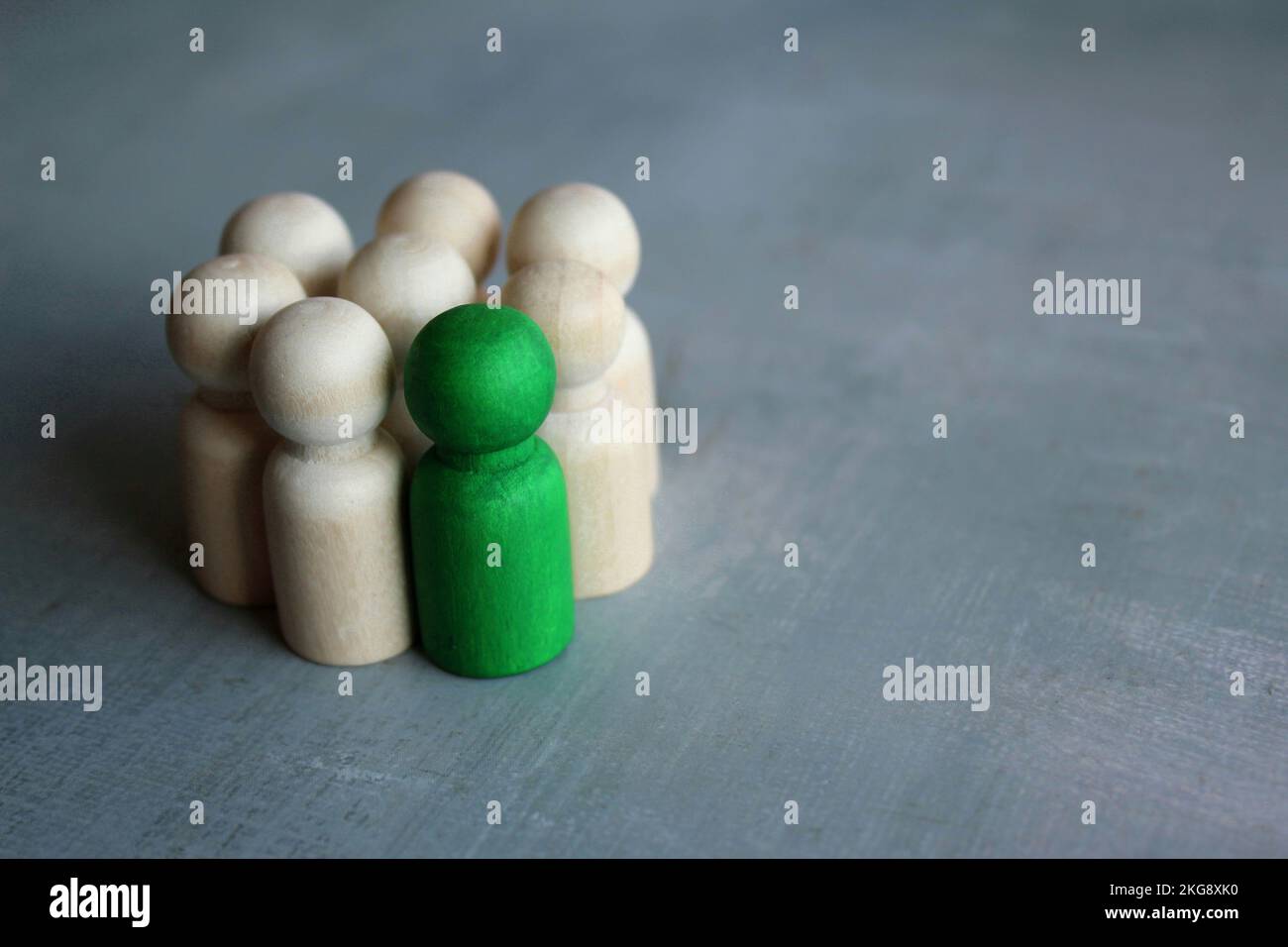 Group of wooden dolls. Stand out from the crowd, center of attention, different, attractive concept Stock Photo