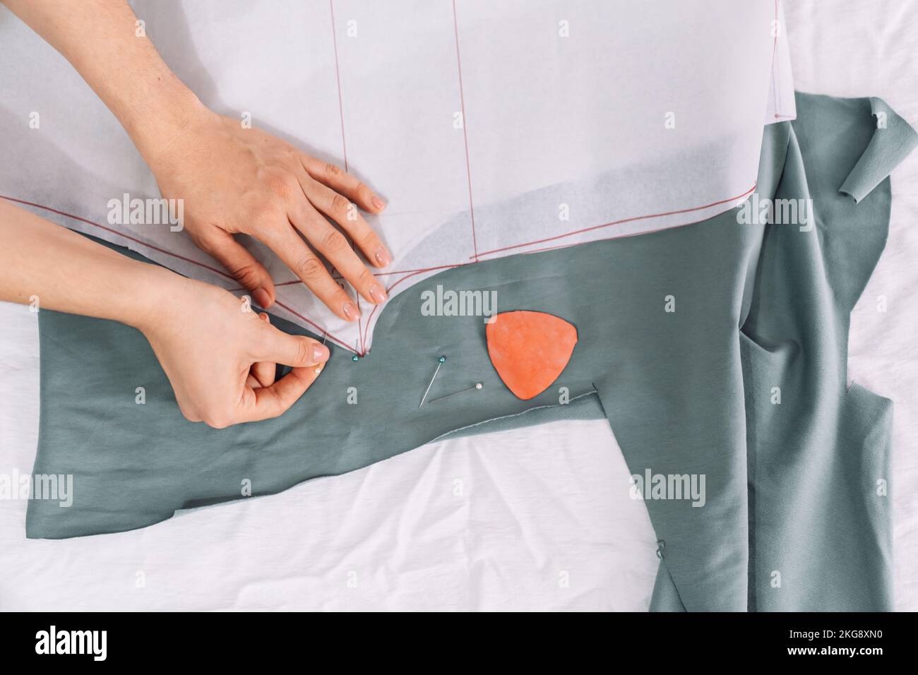 Lady applies a pattern of clothes on the fabric Stock Photo - Alamy