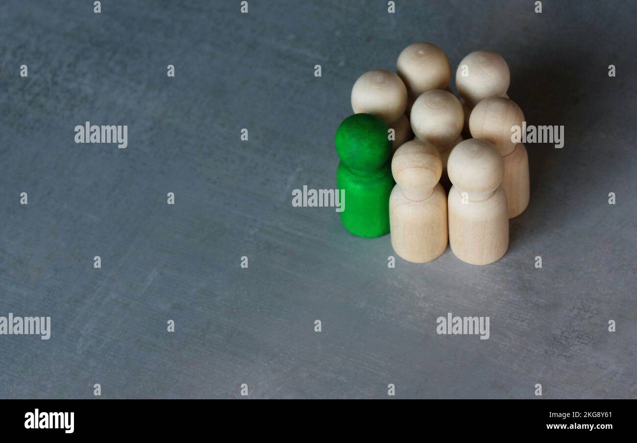 Group of wooden dolls. Stand out from the crowd, center of attention, different, attractive concept Stock Photo