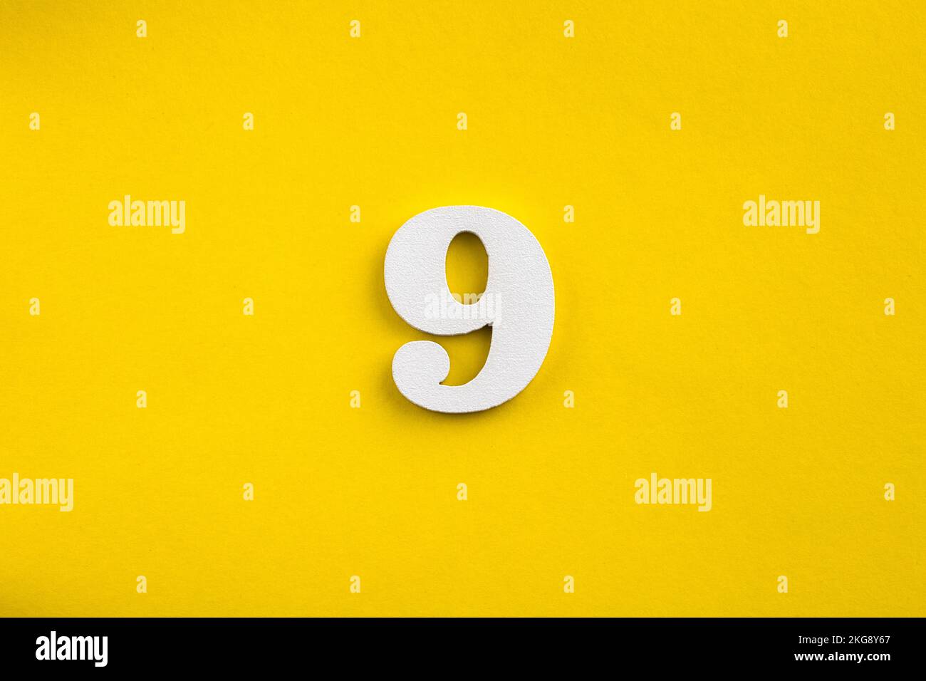 Number 9 - White wooden number on yellow background Stock Photo - Alamy