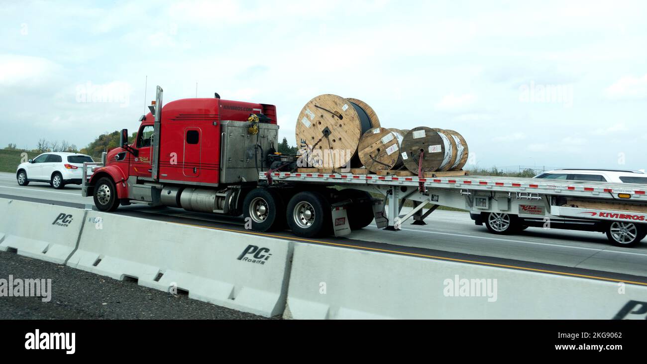 Flatbed truck hauling rolls of cable on the highway. Minneapolis Minnesota MN USA Stock Photo