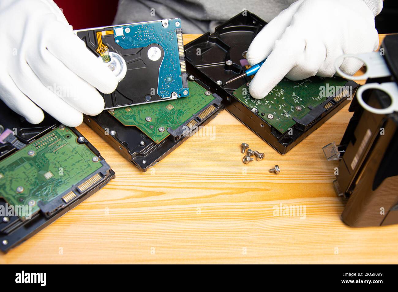 technician is repairing hard drive, hard drive used to store data Stock