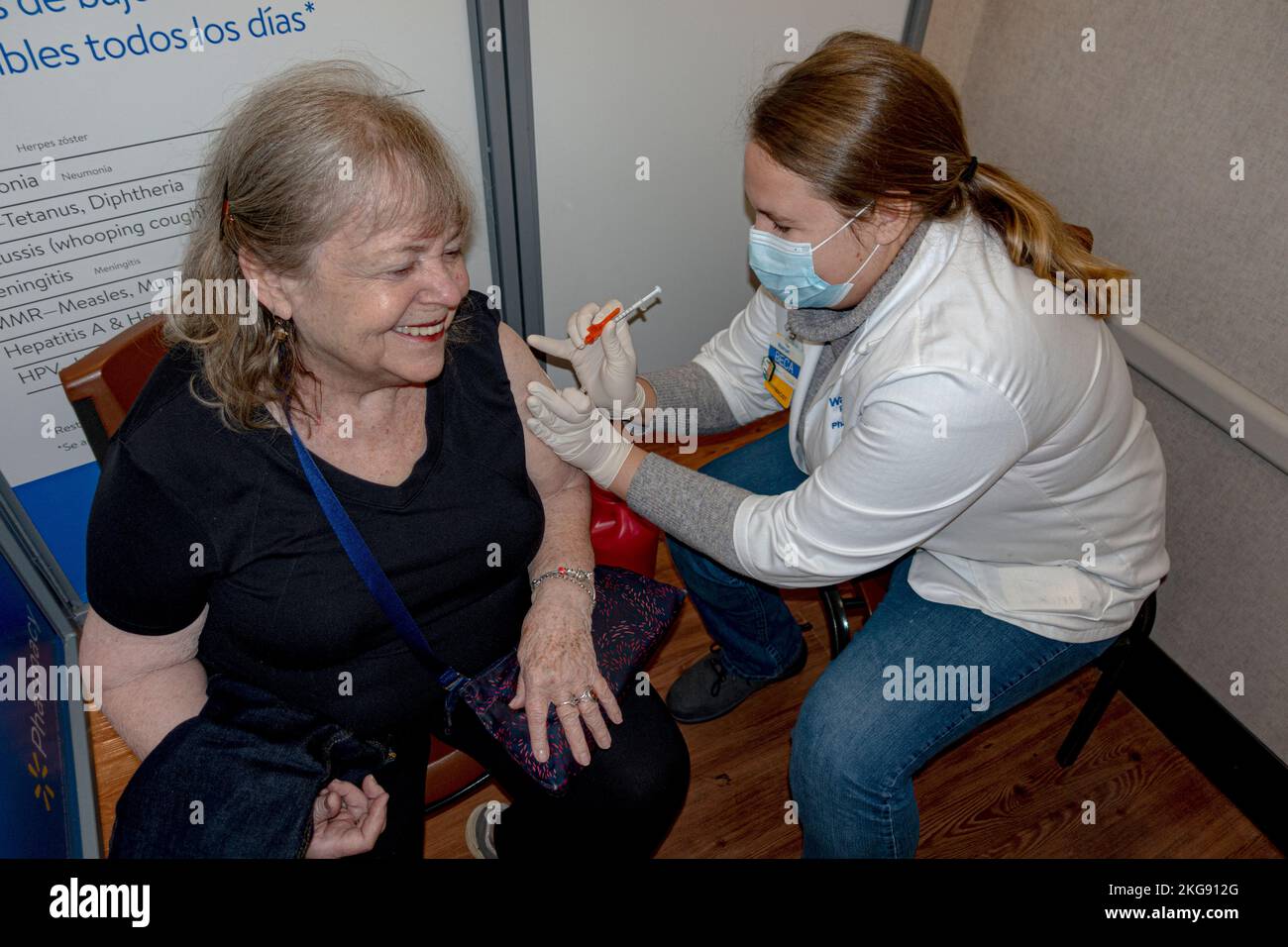 Woman receiving first covid booster at the Walmart pharmacy. Ouch! Fergus Falls Minnesota MN USA Stock Photo