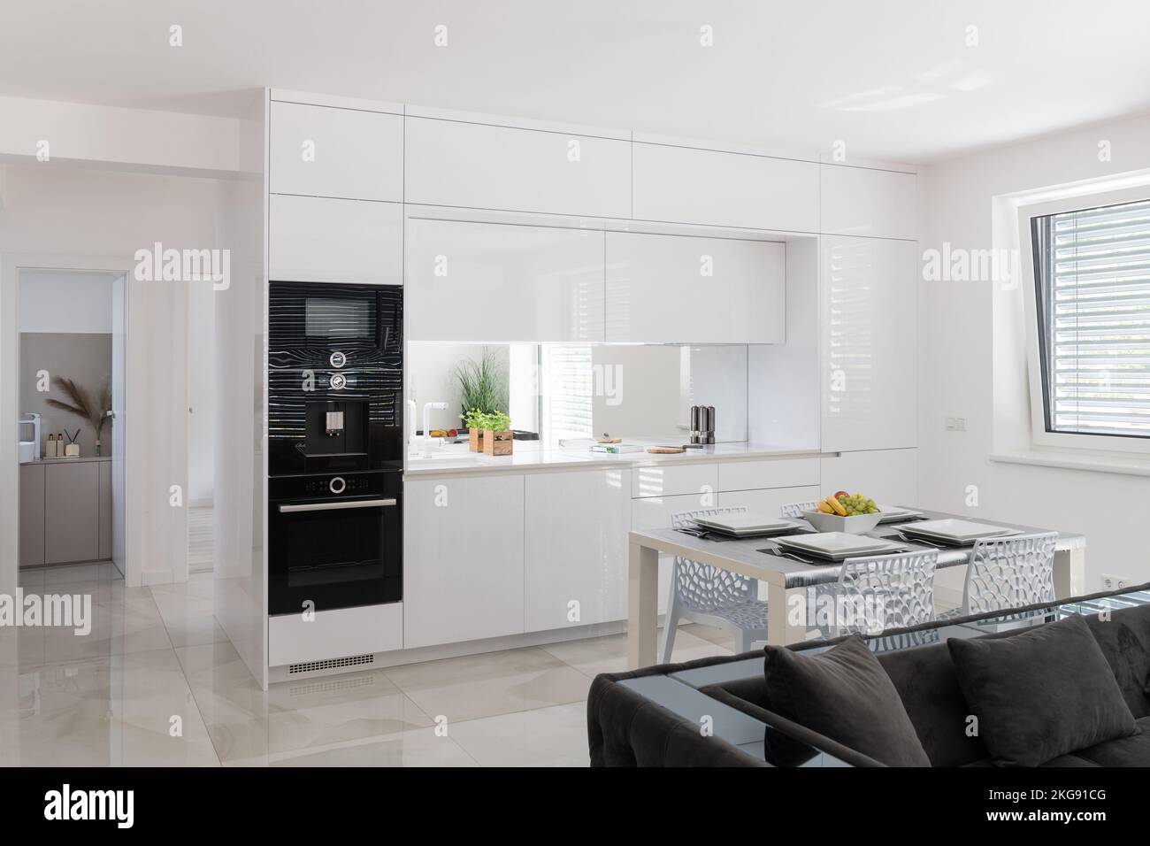 White kitchen with built in appliances in modern apartment Stock Photo ...