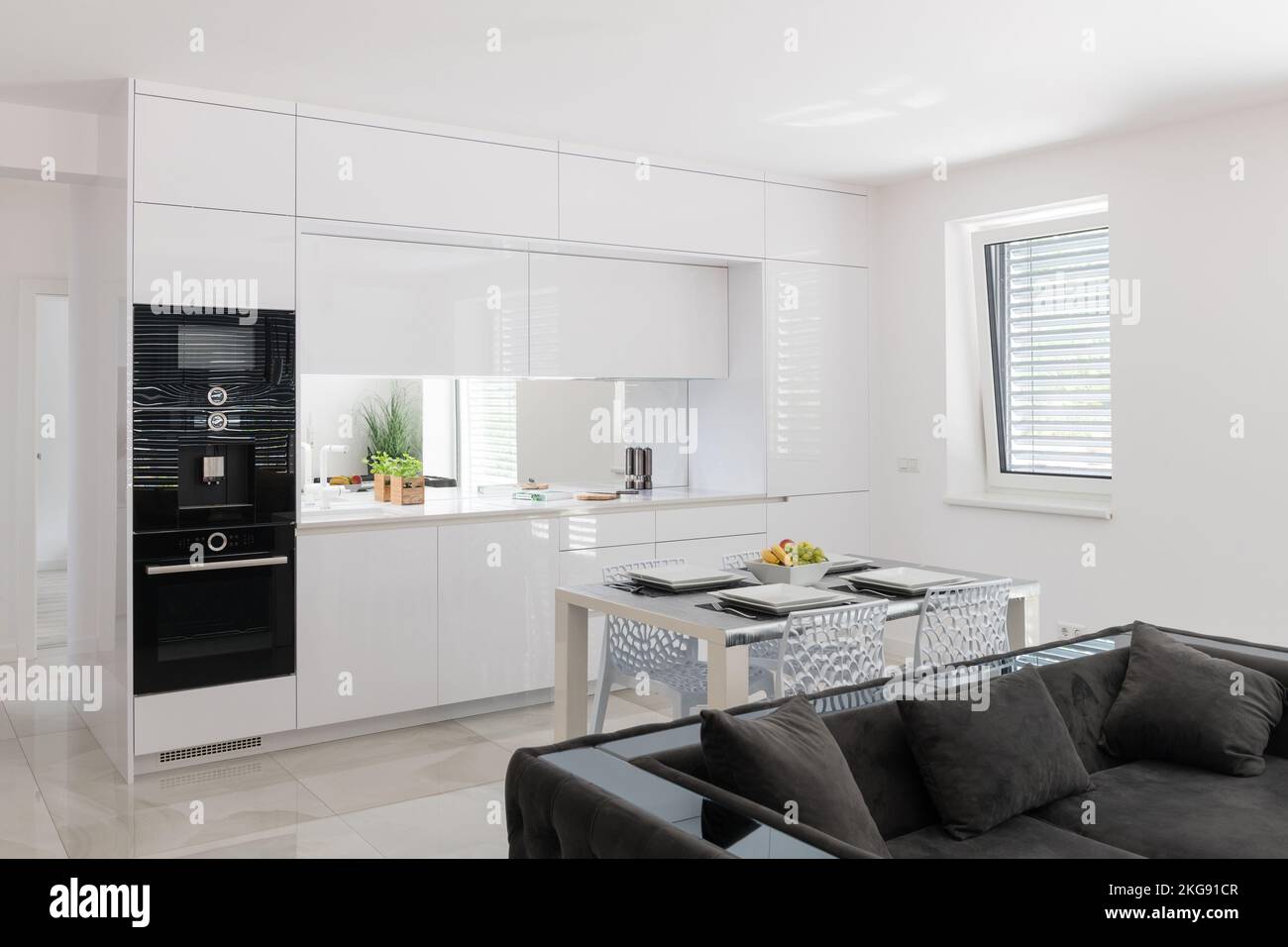 White kitchen with built in appliances in modern apartment Stock Photo ...