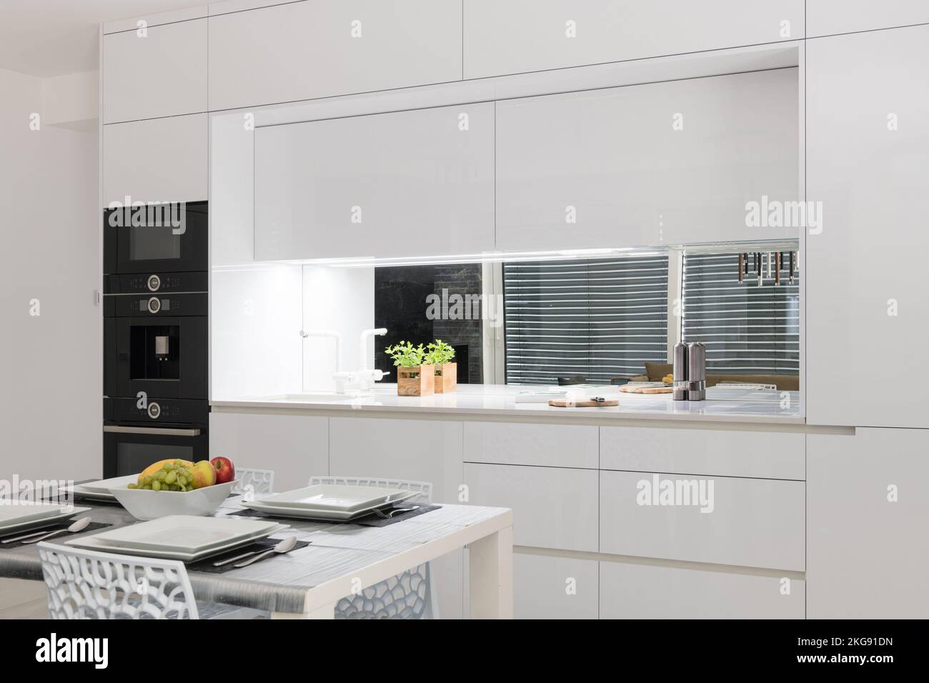 White kitchen with built in appliances in modern apartment Stock Photo ...