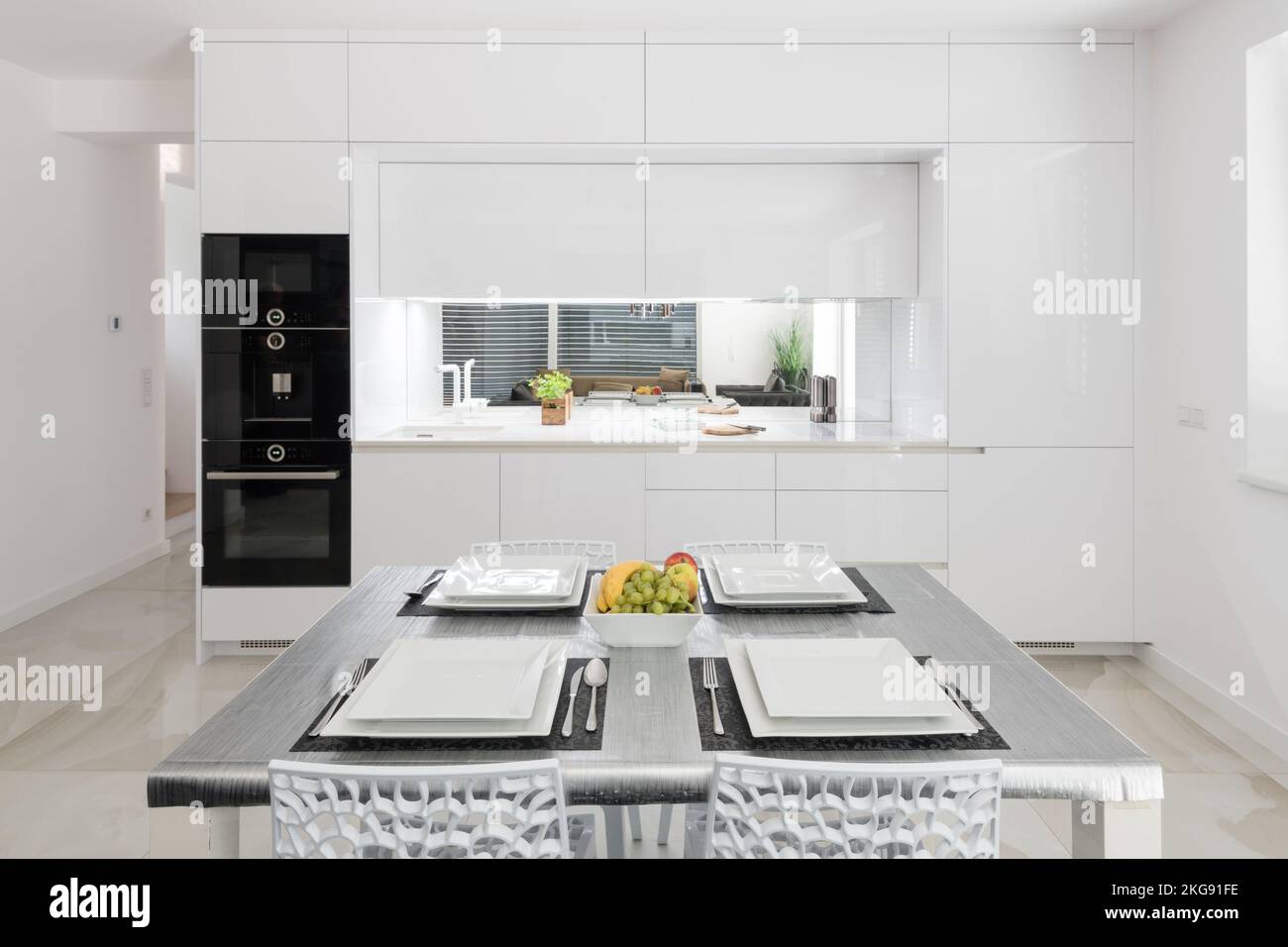 White kitchen with built in appliances in modern apartment Stock Photo ...