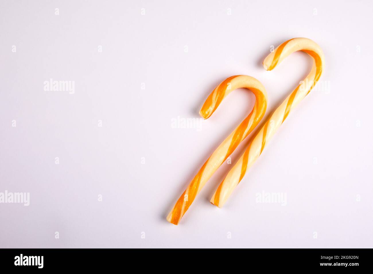 Two yellow candy canes on a white background Stock Photo Alamy