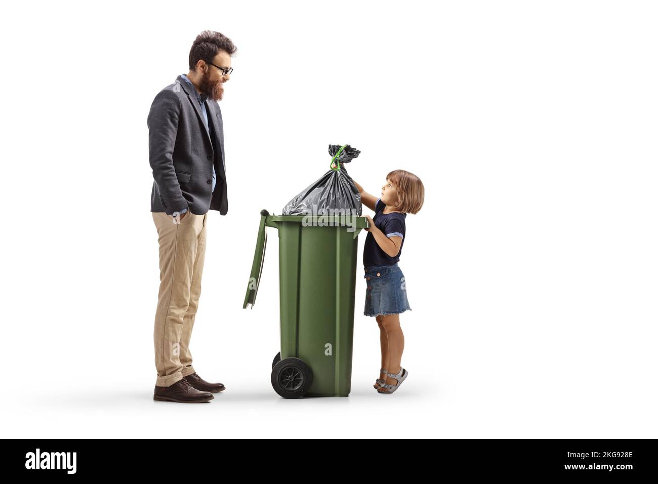 Man watching a little girl throwing a waste bag in a bin isolated on white background Stock Photo