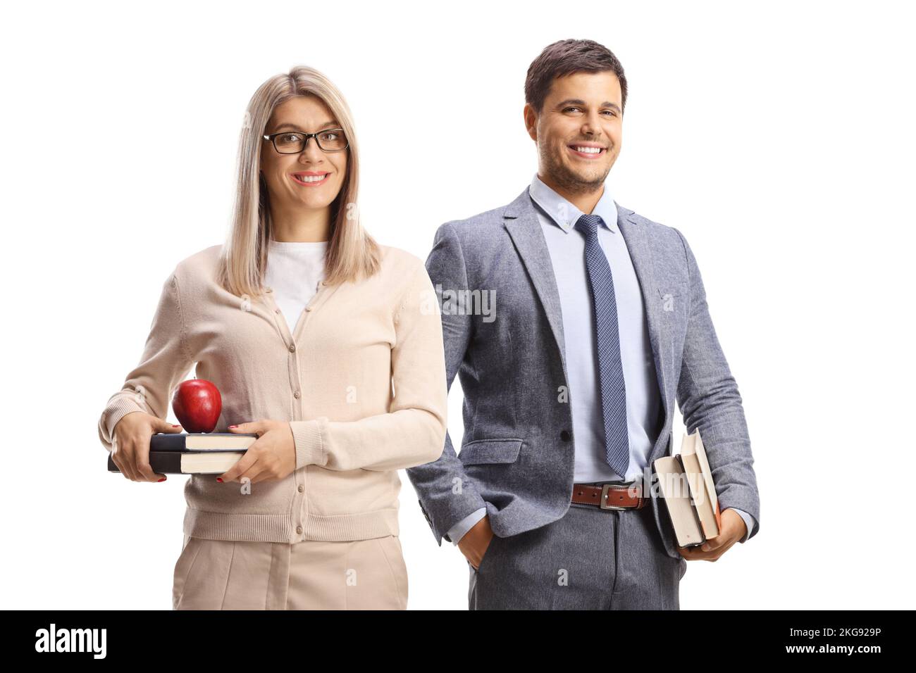 Smiling male and female teacher holding books isolated on white background Stock Photo