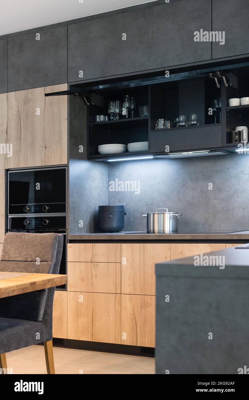 Dark kitchen with built in appliances in modern apartment Stock Photo ...