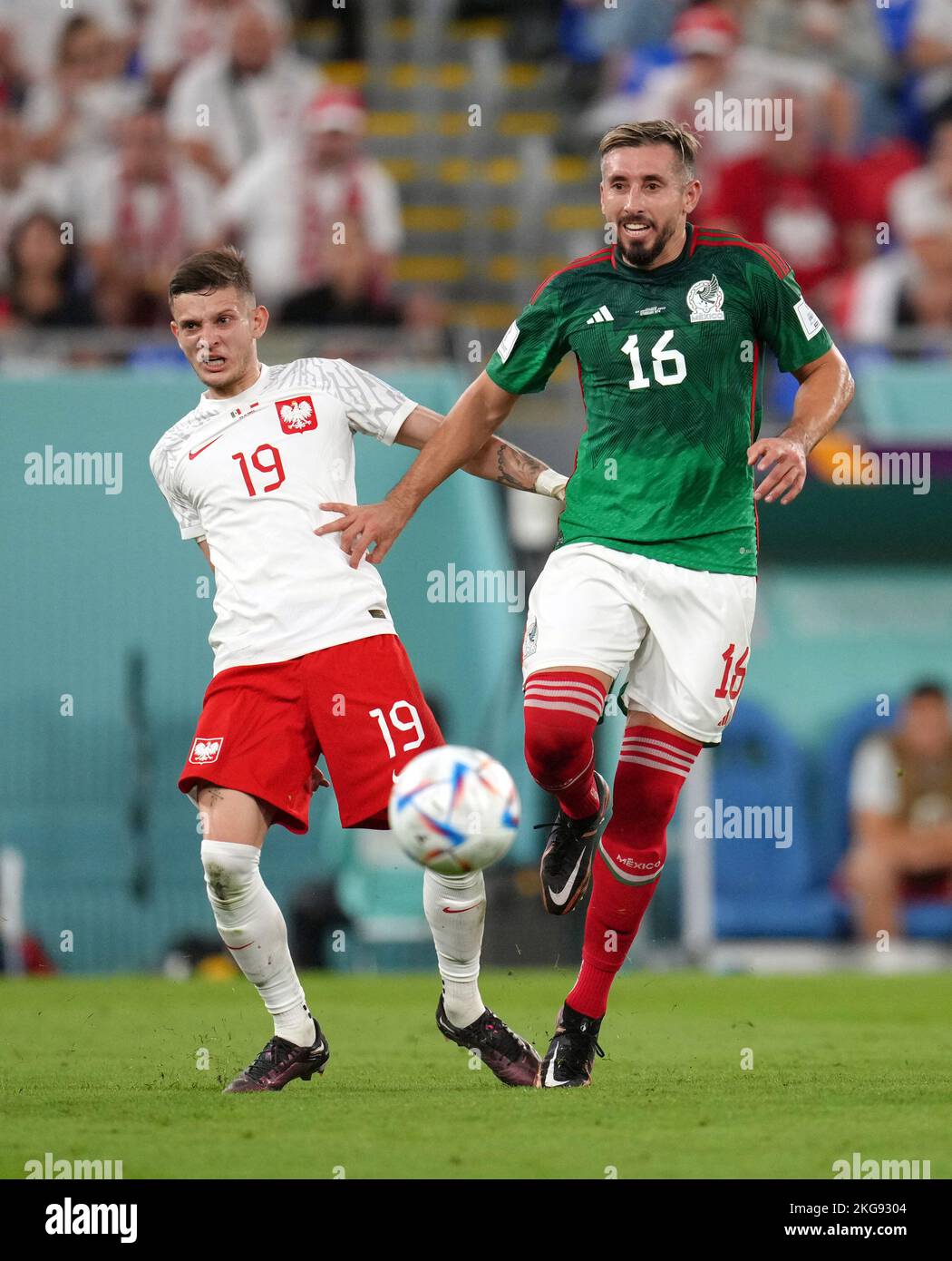 Poland's Sebastian Szymanski (left) and Mexico's Hector Herrera battle for the ball during the FIFA World Cup Group C match at Stadium 974, Rass Abou Aboud. Picture date: Tuesday November 22, 2022. Stock Photo