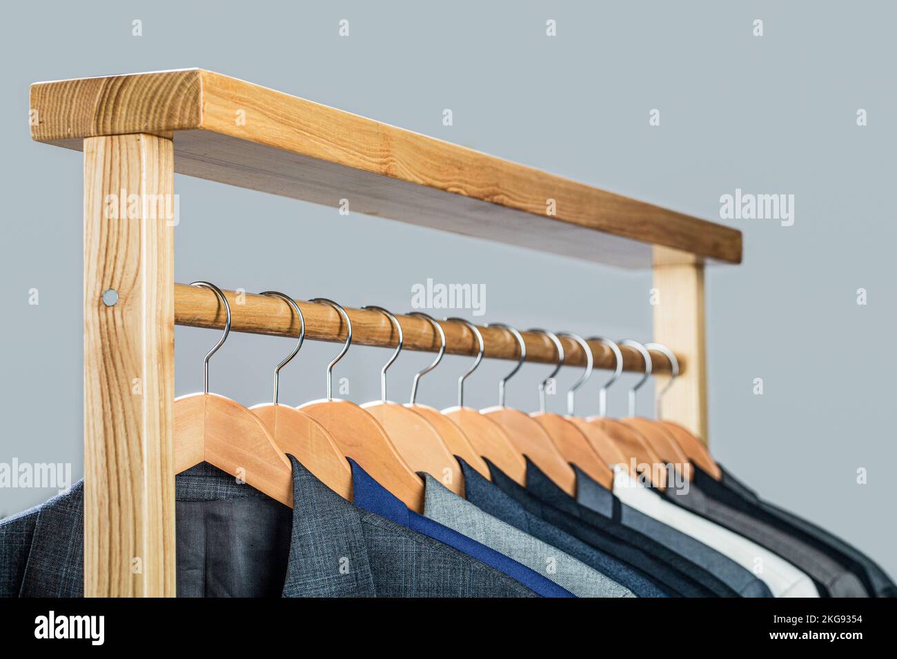 Mens shirts, suit hanging on rack. Hangers with jackets on them in