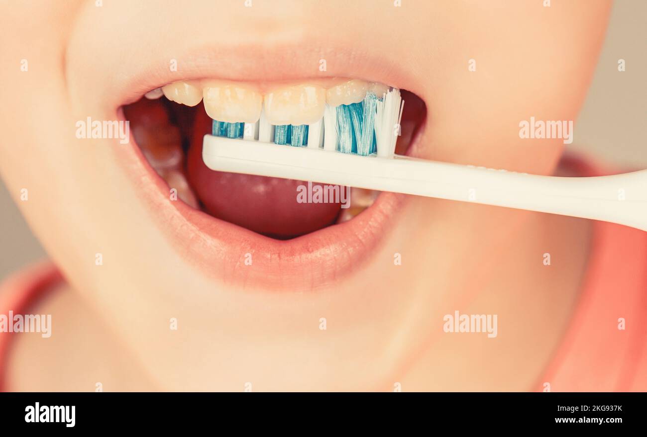 Kid boy brushing teeth. Boy toothbrush white toothpaste. Health care, dental hygiene Stock Photo