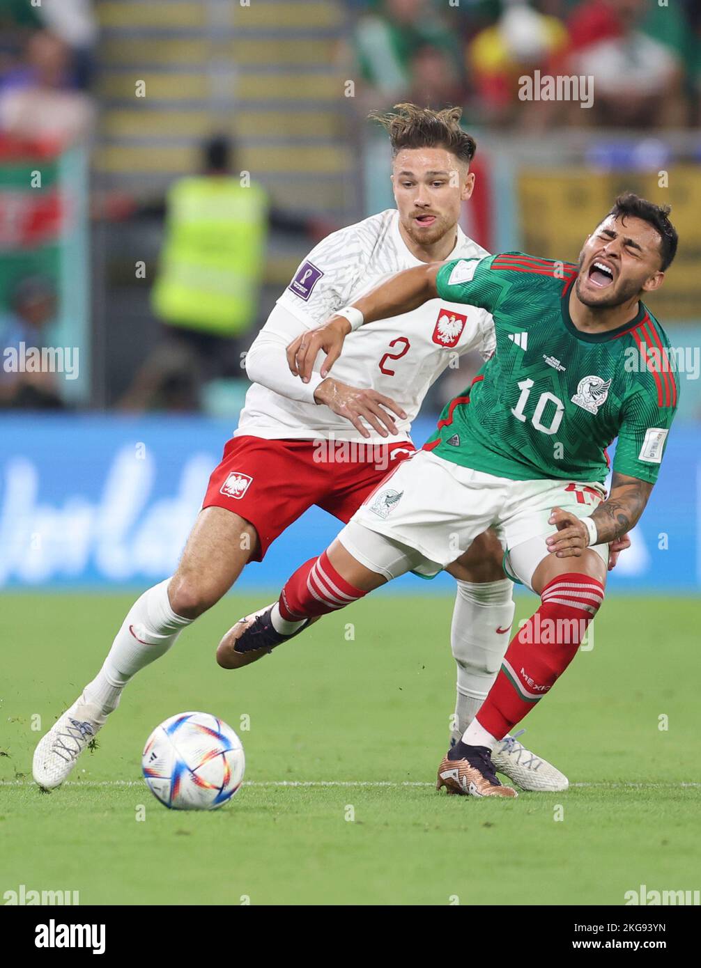 Doha, Qatar. 22nd Nov, 2022. Alexis Vega (R) of Mexico vies with Matty Cash of Poland during the Group C match between Mexico and Poland of the 2022 FIFA World Cup at Ras Abu Aboud (974) Stadium in Doha, Qatar, Nov. 22, 2022. Credit: Jia Haocheng/Xinhua/Alamy Live News Stock Photo