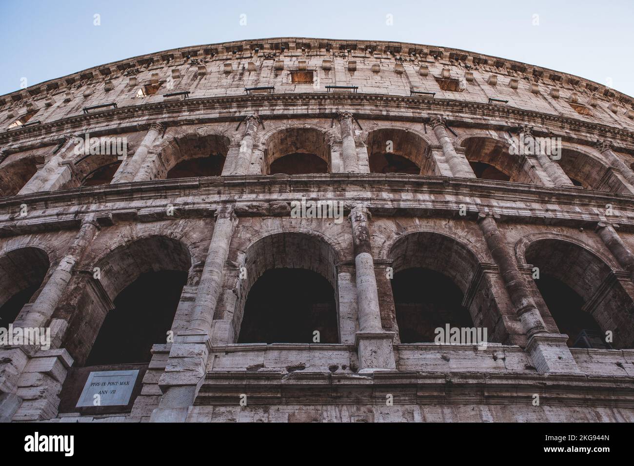 A low angle of the Colosseum amphitheater building in Rome with ...