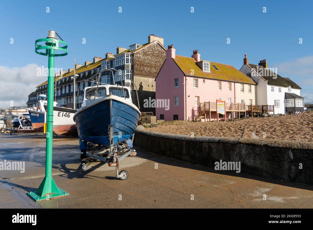 A view of a row of pretty houses near the beach and harbour in the
