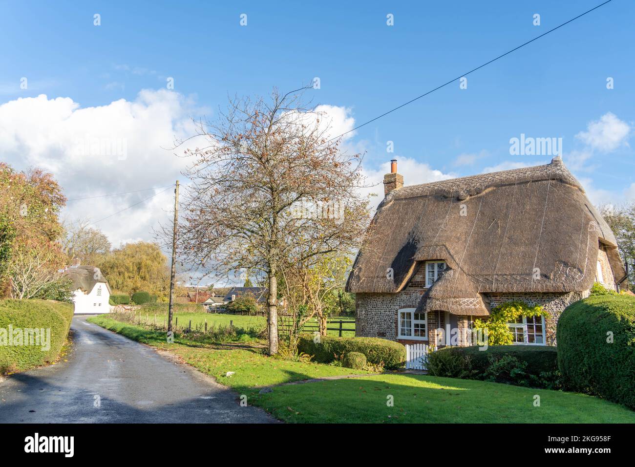 Traditional thatched cottage on a rural road through the village of