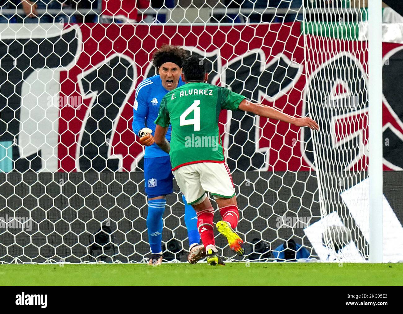 Mexico goalkeeper Guillermo Ochoa (left) celebrates with team-mate Edson Alvarez after saving a penalty from Poland's Robert Lewandowski (not pictured) during the FIFA World Cup Group C match at Stadium 974, Rass Abou Aboud. Picture date: Tuesday November 22, 2022. Stock Photo