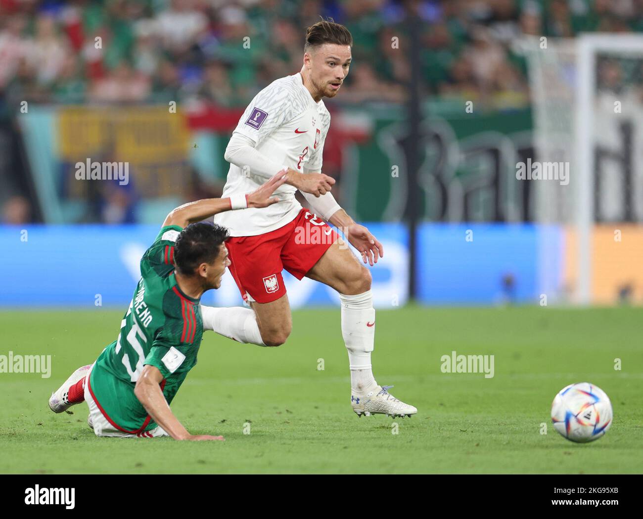 Doha, Qatar. 22nd Nov, 2022. Hector Moreno (L) of Mexico vies with Matty Cash of Poland during the Group C match between Mexico and Poland of the 2022 FIFA World Cup at Ras Abu Aboud (974) Stadium in Doha, Qatar, Nov. 22, 2022. Credit: Jia Haocheng/Xinhua/Alamy Live News Stock Photo