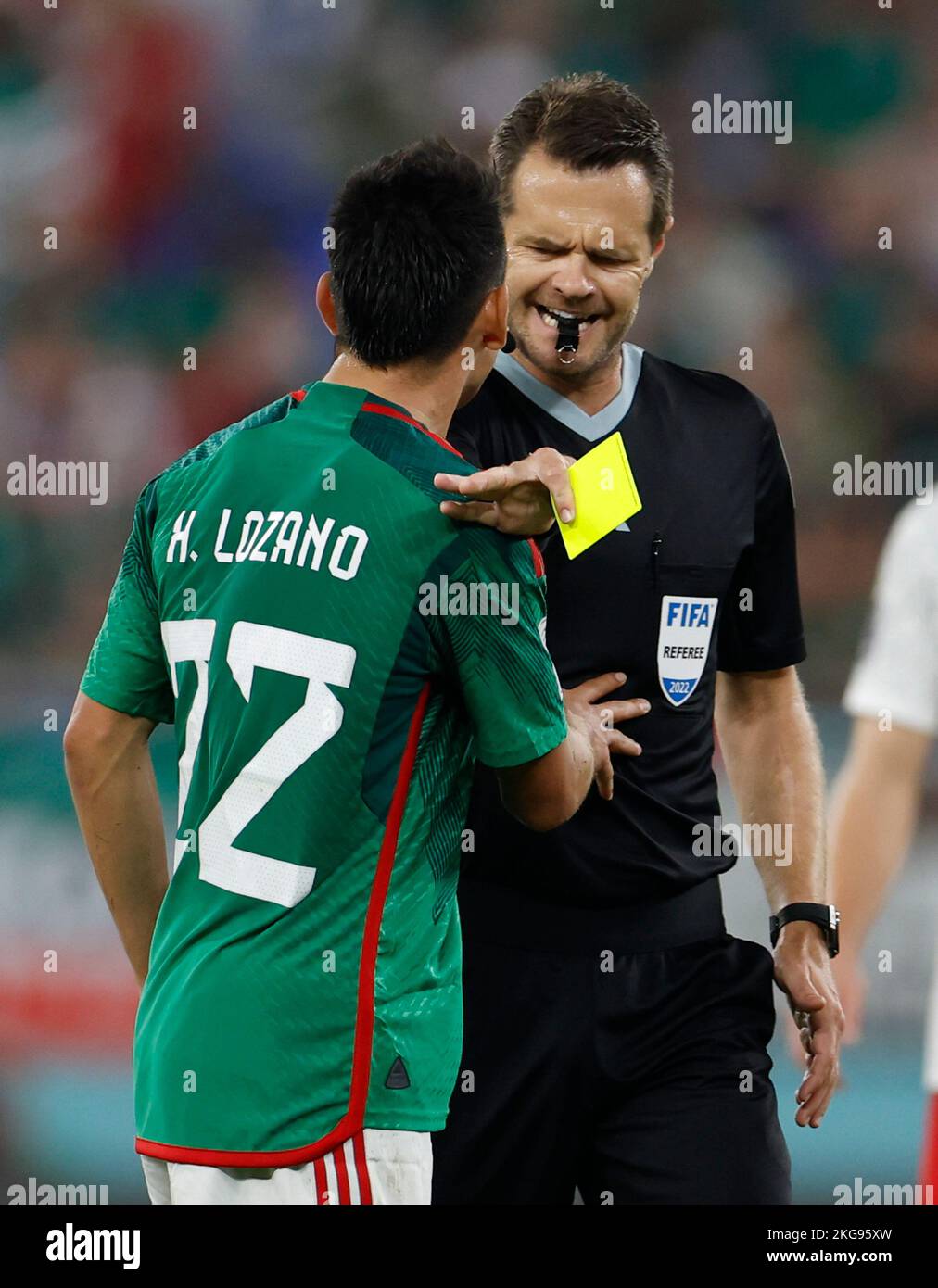 Doha, Qatar. 22nd Nov, 2022. Hirving Lozano (L) of Mexico argues with the referee during the Group C match between Mexico and Poland of the 2022 FIFA World Cup at Ras Abu Aboud (974) Stadium in Doha, Qatar, Nov. 22, 2022. Credit: Wang Lili/Xinhua/Alamy Live News Stock Photo