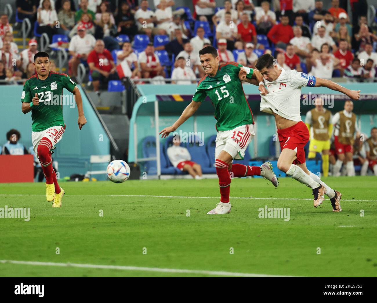 Doha, Qatar. 22nd Nov, 2022. Soccer: World Cup, Mexico - Poland, Preliminary round, Group C, Matchday 1, Stadium 974, Robert Lewandowski (r) of Poland is fouled by Hector Moreno (M) of Mexico in the penalty area. Lewandowski is unable to convert the subsequent penalty kick. Jesus Gallardo of Mexico is on the left. Credit: Christian Charisius/dpa/Alamy Live News Stock Photo