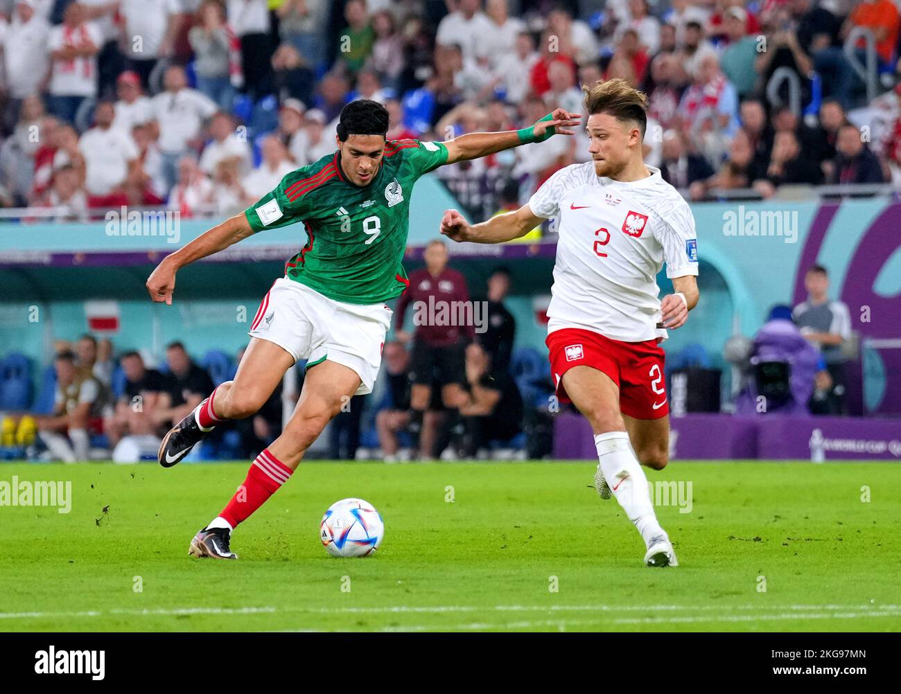 Mexico's Raul Jimenez (left) and Poland's Matty Cash battle for the ball during the FIFA World Cup Group C match at Stadium 974, Rass Abou Aboud. Picture date: Tuesday November 22, 2022. Stock Photo