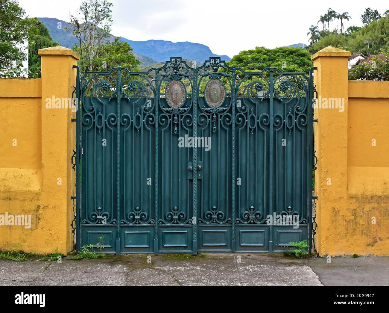 Green gate on yellow facade in Petropolis, Rio de Janeiro, Brazil Stock Photo