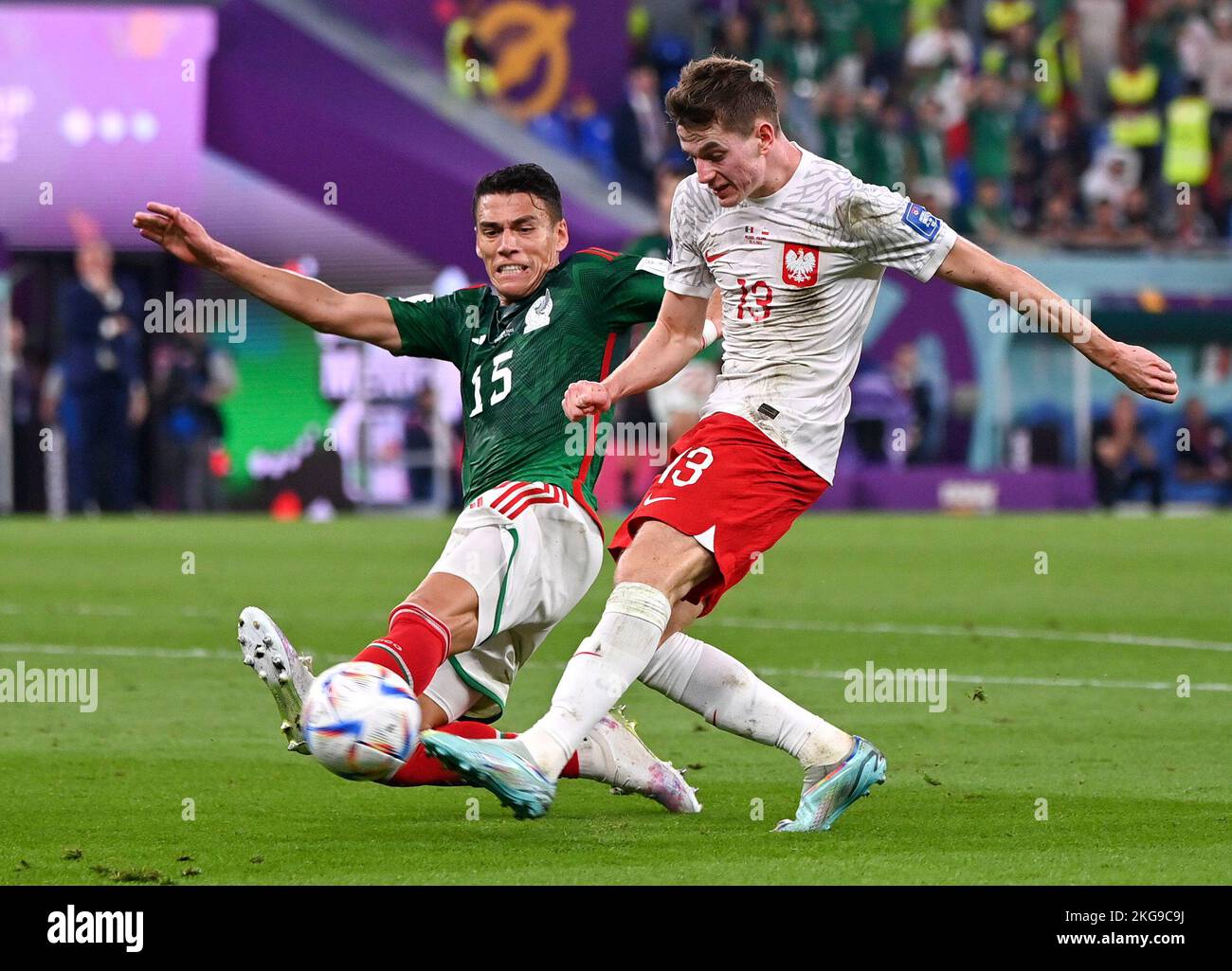 Doha, Qatar. 22nd Nov, 2022. Hector Moreno (L) of Mexico vies with Jakub Kaminski of Poland during the Group C match between Mexico and Poland of the 2022 FIFA World Cup at Ras Abu Aboud (974) Stadium in Doha, Qatar, Nov. 22, 2022. Credit: Chen Cheng/Xinhua/Alamy Live News Stock Photo