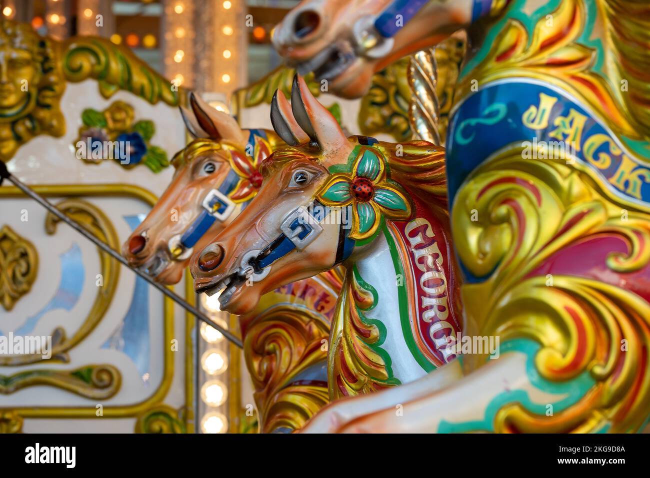 The bright and vibrant colours of the horses on a funfair carousel. Stock Photo