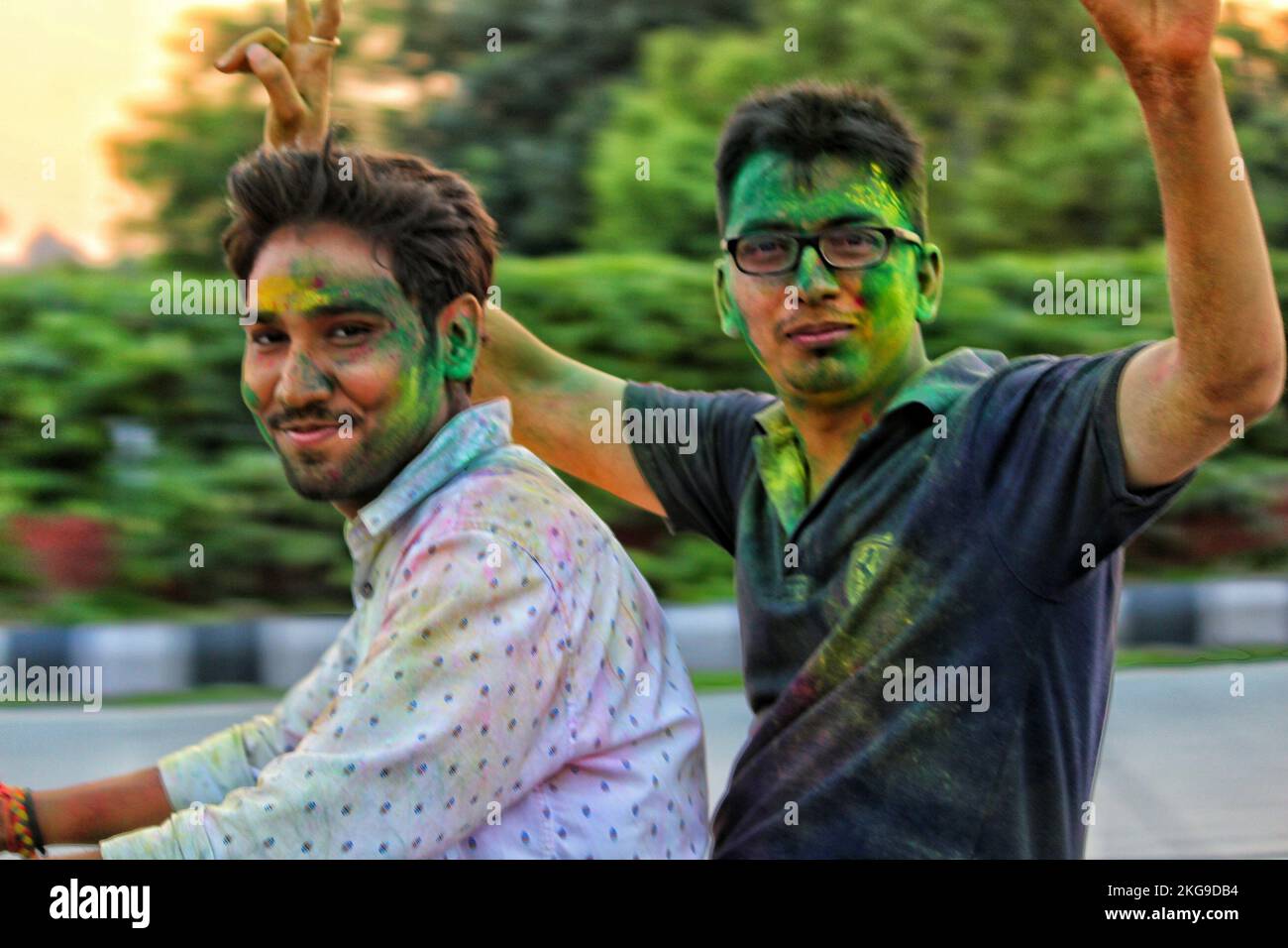 Delhi, India -Indian People face smeared with colors participate in Ganesh Visarjan Stock Photo