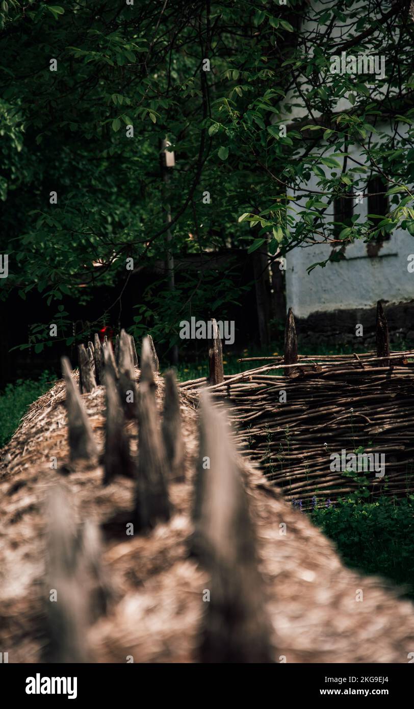 A vertical shot of a wooden fence made od branches at Dimitrie Gusti National Village Museum Stock Photo