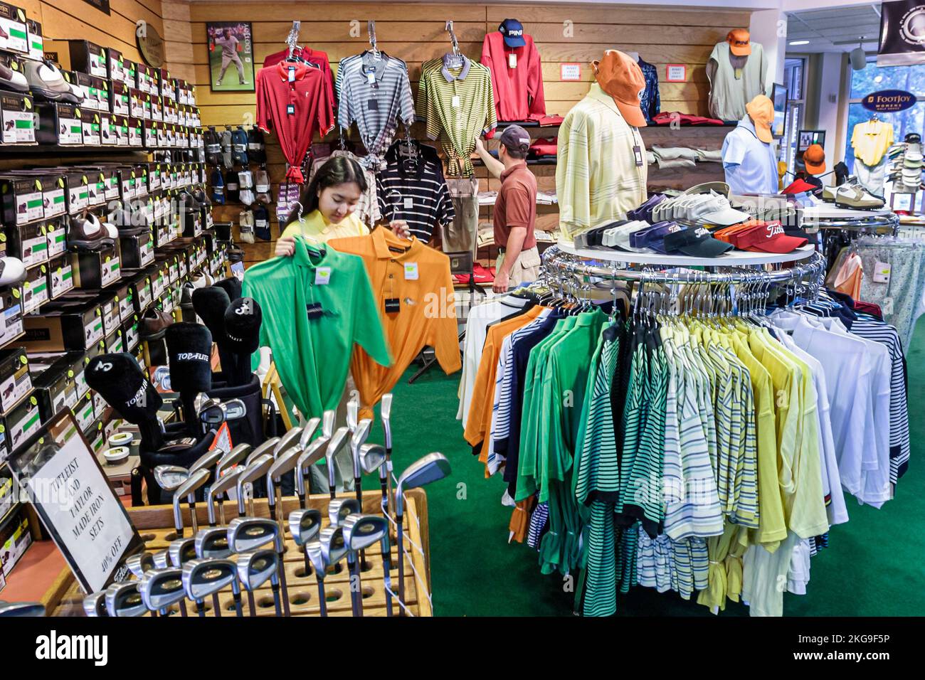 Virginia Newport News Golf Club at Deer Run pro shop,shopping Asian woman female sports clothing shirt shirts compares comparing, Stock Photo