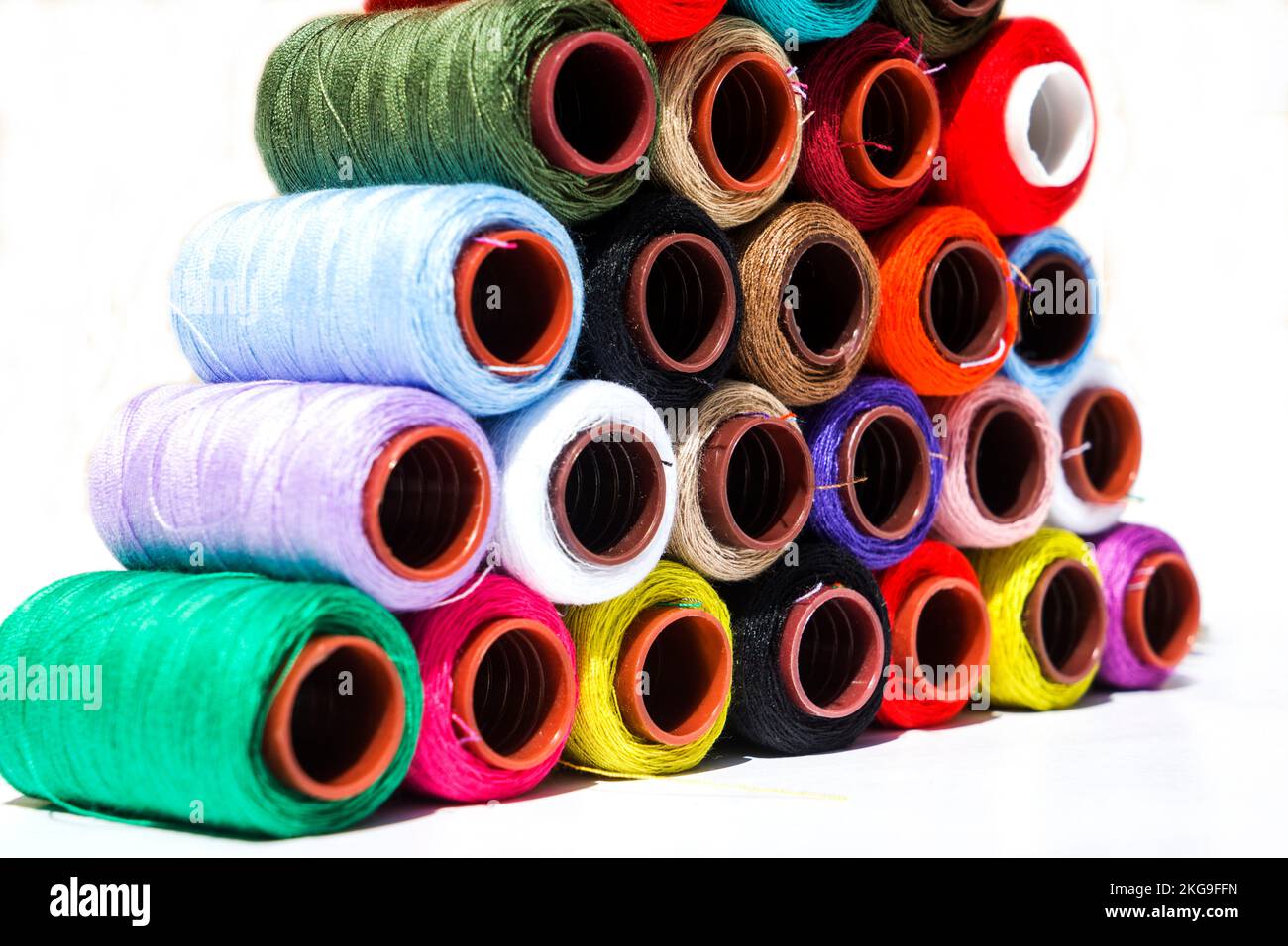 Multi-color silk thread coils on white background. Stock Photo