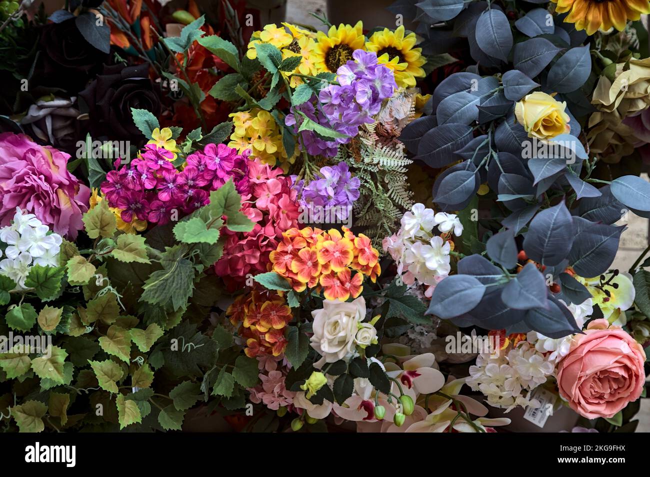Fake  flowers on a stall seen up close Stock Photo