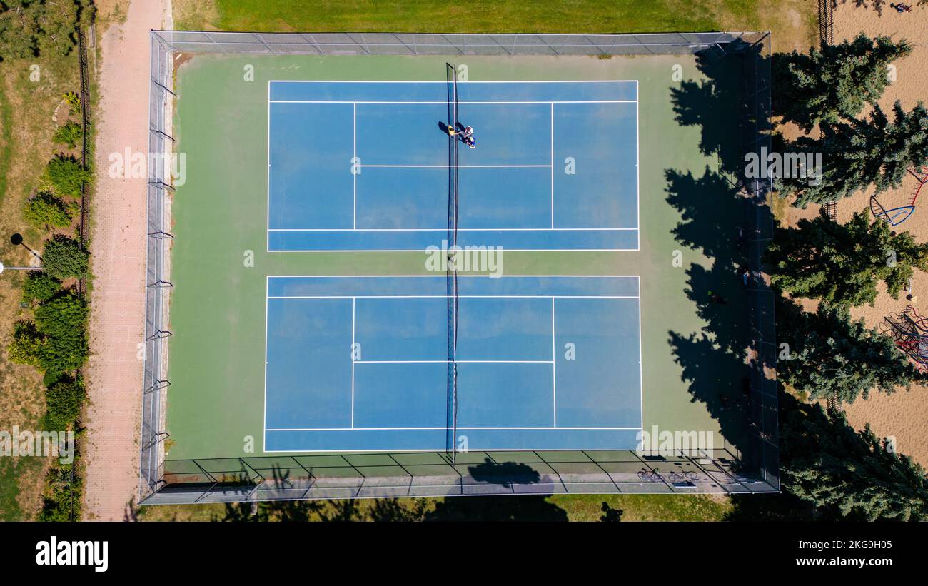 An aerial view of Tennis Court with trees in a field Stock Photo