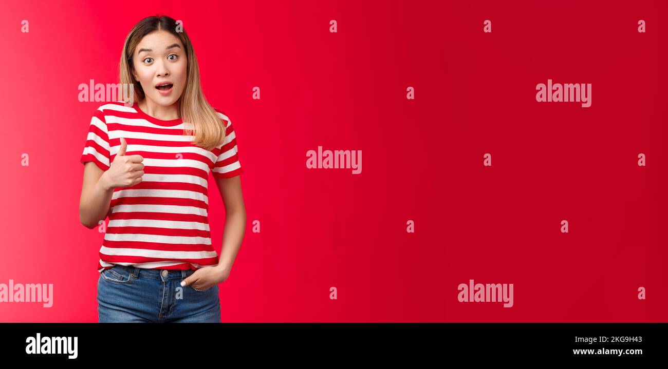 Surprised impressed asian blond girl judge good performance give thumb