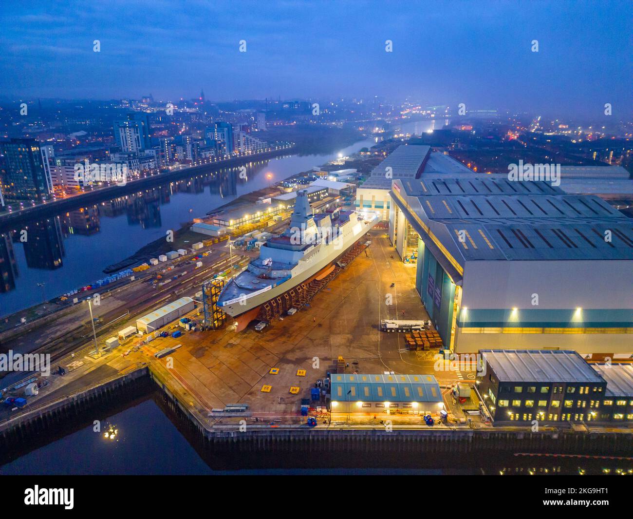 Glasgow, Scotland, UK. 22 November 2022. Aerial view of HMS Glasgow at BAE Systems Govan shipyard  just before being transferred by barge to nearby Scotstoun shipyard on the River Clyde. The ship is a Type 26 anti-submarine frigate.  Iain Masterton/Alamy Live News Stock Photo