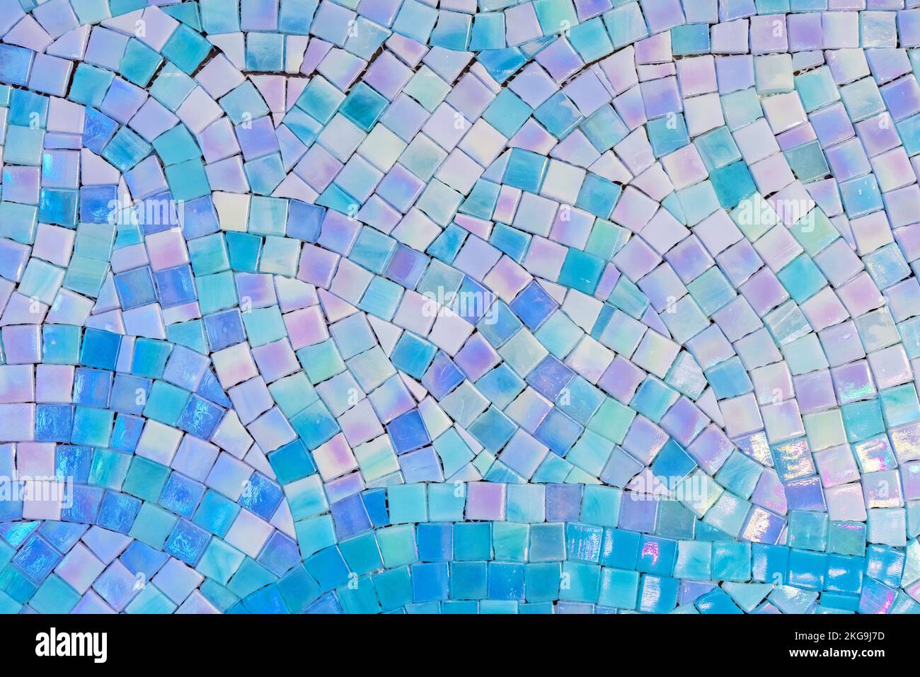 Ceramic mosaic tiles with white, blue and turquoise squares laid out in a chaotic pattern. Stock Photo